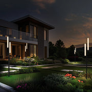At night, several floor lamps stand sentinel at the four corners of the courtyard, their soft glow harmonizing beautifully with the surrounding trees, creating a serene and cozy ambiance.