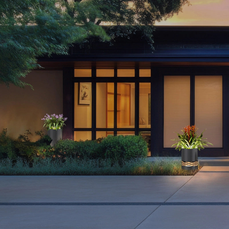 The exterior of a house, there are several pots of green plants in front of the door, among which the potted plants are lamps with lighting functions, which are not afraid of wind and rain