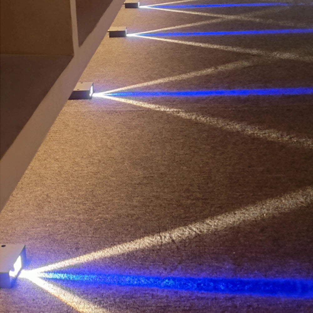 Triple Glow Path Light is arranged on the carpet, emitting blue and yellow-white light.