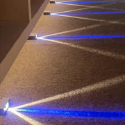 Triple Glow Path Light is arranged on the carpet, emitting blue and yellow-white light.
